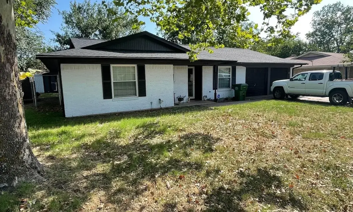 Professional roofing crew working on a residential roof in The Crossings